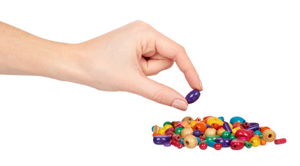 Hand with colored wooden beads, decorative accessory for hand made.
