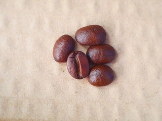 organic coffee beans on brown paper background