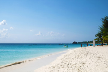 Fototapeta na wymiar Amazing paradise ocean beach view People chilling on Zanzibar island