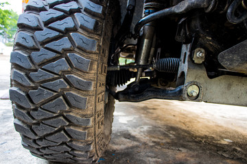 The off-road car or 4x4 car shows the suspension and shock-up system and the big tire for adventure...