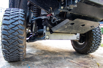 The off-road car or 4x4 car shows the suspension and shock-up system and the big tire for adventure...