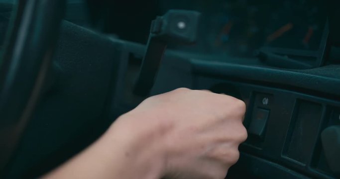 Woman putting key in car ignition