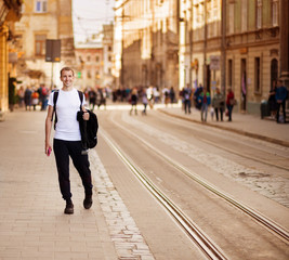 Young traveler man walk alone by old europen street