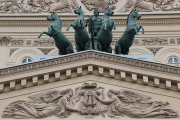 sculpture with horses and bas-reliefs on the facade of the theater in Moscow