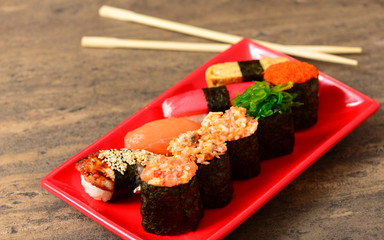 Plate with sushi near chopsticks