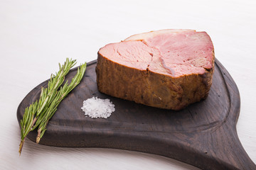 Food, meat and delicious concept - horse meat with salt on board