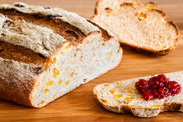 Artisan whole grain bread with raspberry jam. Tasty and healthy breakfast