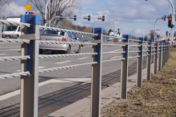 Close-up of steel ropes. Cable barrier, also called guard cable or wire road safety barrier, is...