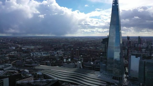 Aerial drone video of iconic landmark building called "The Shard" in the heart of city of London, United Kingdom