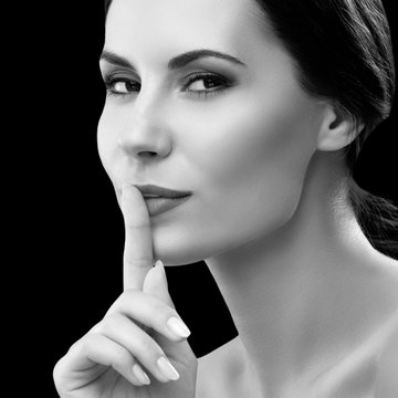 Woman keeping finger on her lips