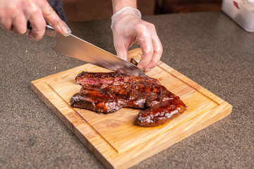 food, delicious and craft concept - Man cutting horse steak