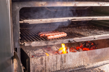 food, delicious and meat concept - roasting horse meat sausages grilled.