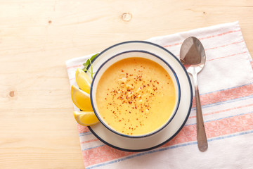 Traditional lentil soup in a white plate on a wooden table