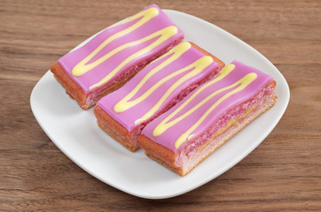 Slices of layers cake with icing in plate