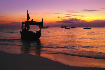 Ships against the background of a beautiful sunset on the ocean in Africa. Zanzibar Island, Tanzania