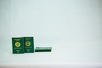Ecowas nigeria Internation passport on heap of naira cash