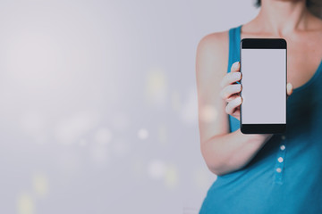A woman holding a smartphone in her hands. Template for design or app