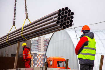The Builder helps to unload pipes