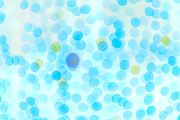 Blurred blue bokeh on light background. Illustration of the structure of the objects under high magnification.