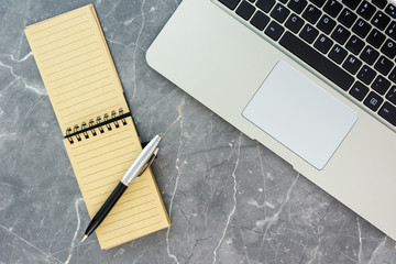 top of the table with notebook pencil and laptop keyboard