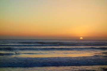 Obraz premium Sunset in Taghazout with a surfer in the background, Morocco