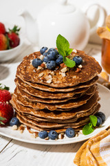 stack of homemade delicious pancakes for breakfast, vertical closeup