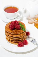 stack of pancakes with raspberries for breakfast, vertical top view
