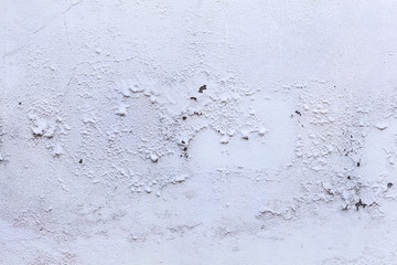 plain old aged white colored painted faded weathered peeled textured pattern on plastered concrete house wall surface background. Detailed backdrop, abstract design and structural architecture concept
