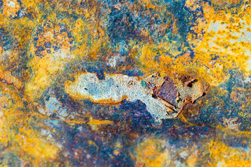 Old rusty metal background with peeling gray paint. Rusty flaky cracked metal surface. Abstract textures of the surface of the old metal