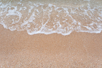 Soft wave of blue ocean on sandy beach at andaman sea Phuket Thailand. Summer day and sandy beach background with copy space.