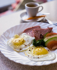 eggs with sausages and cheese and vegetables for breakfast