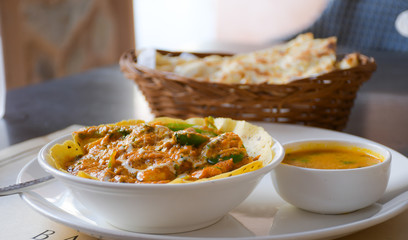 Chicken tikka masala, delicious Indian dish with naan bread.
