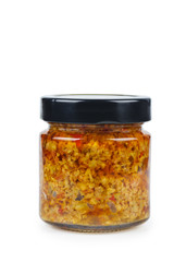 Glass jar with red pesto sauce isolated on white background