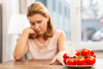 Obraz na płótnie Canvas Woman feeling uncomfortable having allergy to tomatoes