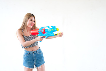 Asian sexy woman with gun water in hand on white background,Festival songkran day at thailand,The best of festival of thai,Land of  smile