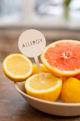 Lemons and grapefruits standing on table near the window