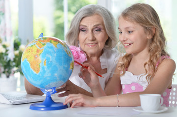 Portrait of grandmother and granddaughter doing homework