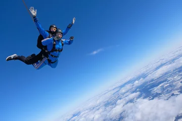 Fotobehang Tandem skydiving. Two guys are having fun in the sky. © Sky Antonio