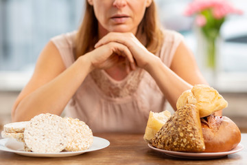 Woman with allergy choosing between crisps and bread