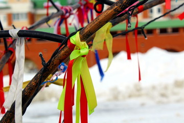 Colorful ribbons hanged for good luck on the iron tree