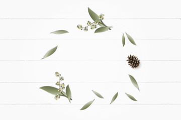 Flat lay top view elegant white composition paper botanic garden plant leaf flower pine cone on wooden background