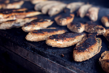 A lot of fish on the grill. Street food cooking process