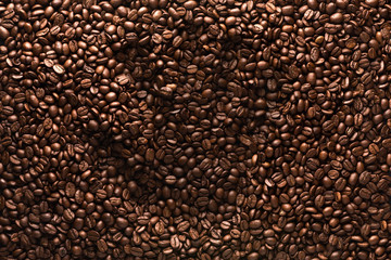 Coffee beans composition, handprint on coffee beans, coffee beans background.