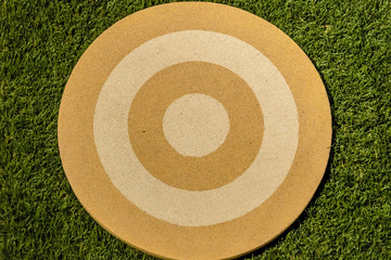 On a grass background, the objective is placed with circles in golden tones