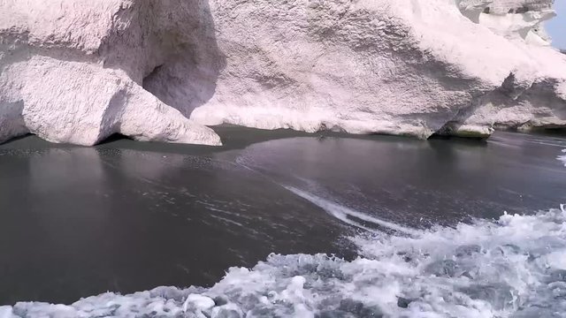 Panorama of famous Cyprus white chalk clifs on landmark Governors beach with black sand, Mediterranean sea.