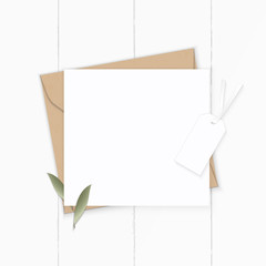 Flat lay top view elegant white composition letter kraft paper envelope nature leaf and tag on wooden background