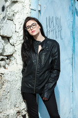 Glamorous young woman in black leather jacket. Portrait of cute young business woman outdoor