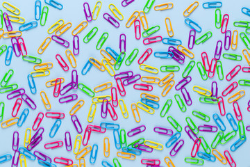 Paper color clip notebook on blue background. Flat lay.