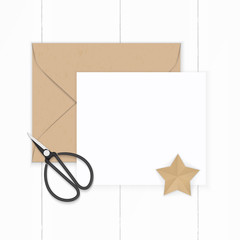 Flat lay top view elegant white composition paper brown kraft envelope star shape craft and metal vintage scissors on wooden background