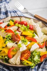 Salad with cheese and fresh vegetables.